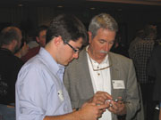 Team member Tony Brown shows the NearBuy real estate app to Stanford University registrar Tom Brown at Apple's WorldWide Developer Conference in San Francisco, June 10, 2009.  Photo by Keith Politte, RJI.