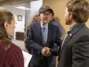 Gary L. Turner, center, shakes hands with Kyle Smith, the president of the student veterans group, outside the newly expanded MU Veterans Center. The new addition, which measures 960 square feet, can accommodate up to 40 students.